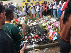 Candles, cards and flowers outside the home